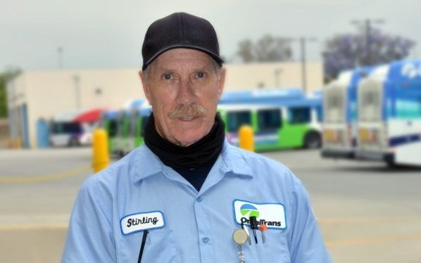Image of Omnitrans employee, Stirling, in bus yard