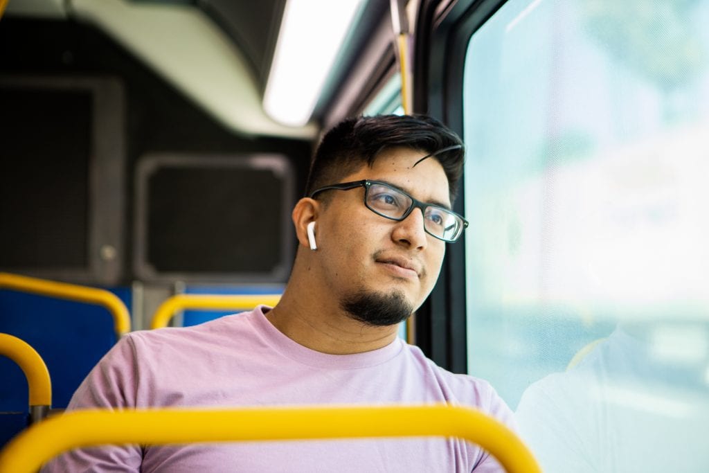 Customer listening to music on the bus