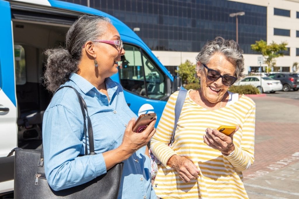 Two senior women looking at phones